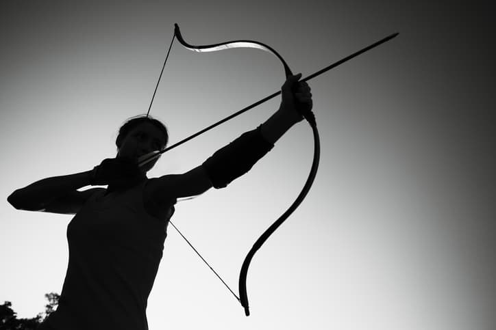 female-archer-in-the-field-at-sunset